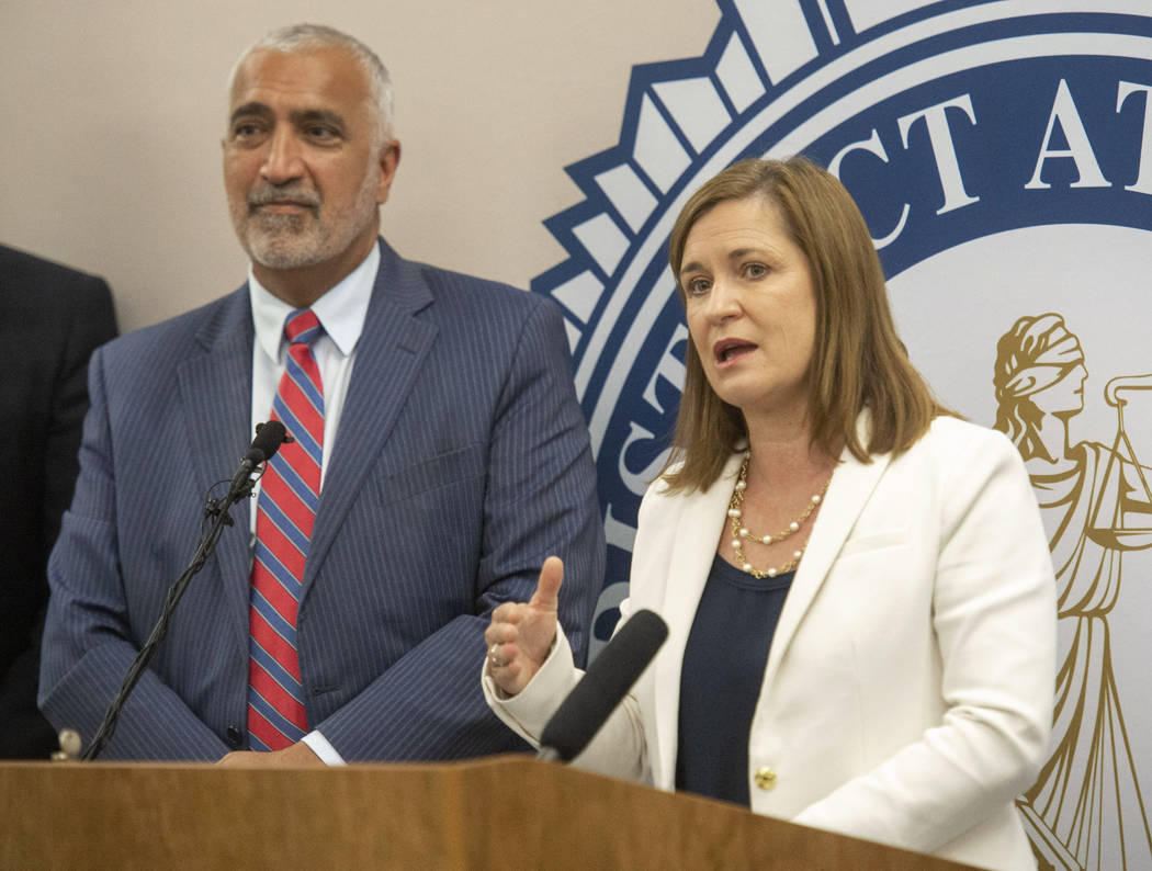 In this Tuesday, July 30, 2019, photo, Salt Lake County District Attorney Sim Gill listens as S ...