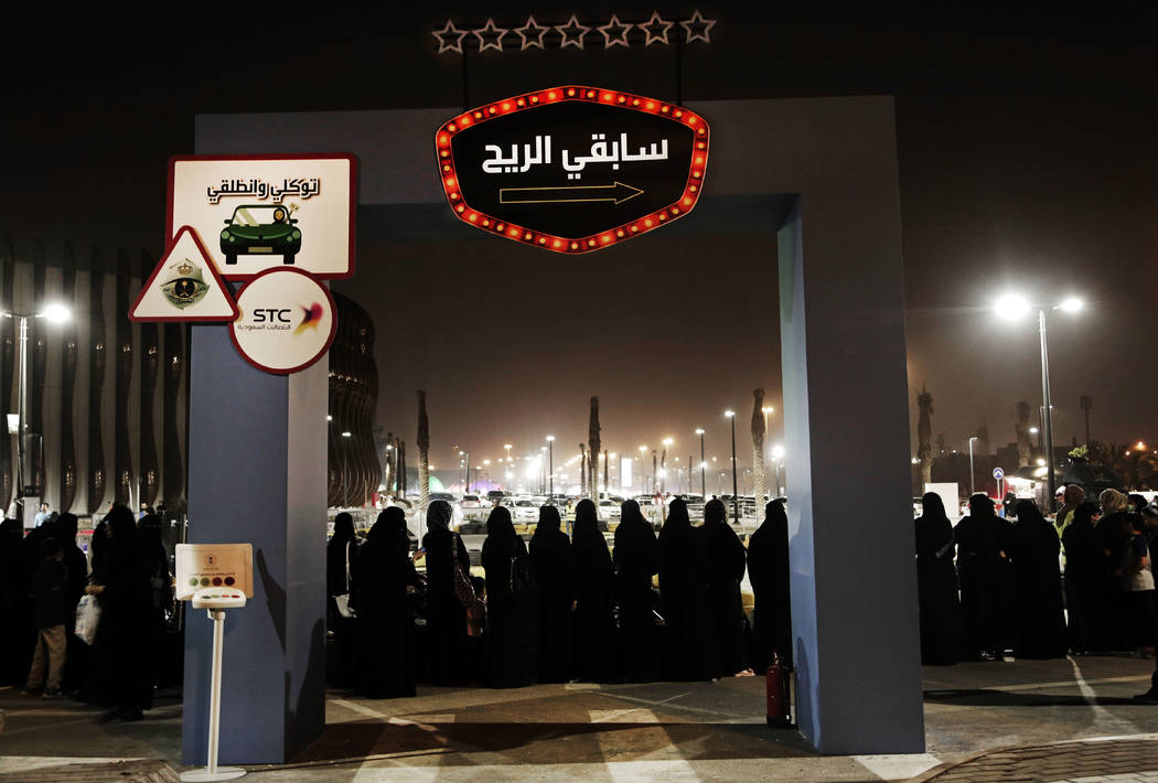 FILE - In this June 22, 2018, file photo, women wait in line to ride go carts at a road safety ...