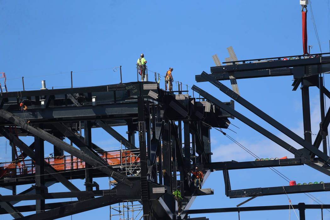 The final steel canopy truss goes up at the Raider stadium construction site in Las Vegas, Thur ...