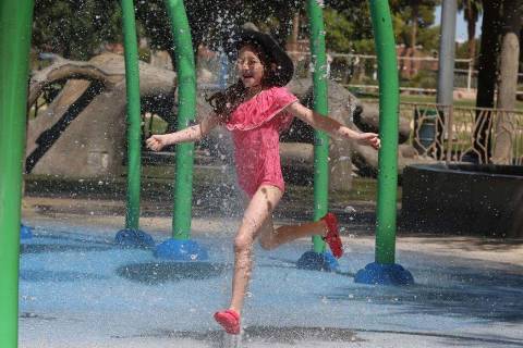 Elle Edwards, 7, cools herself as she plays at Sunset Park, July 29, 2019, in Las Vegas. (Bizua ...