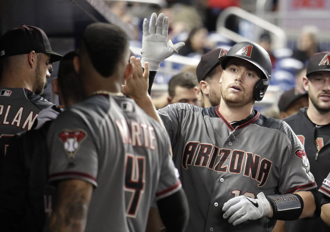 Arizona Diamondbacks' Nick Ahmed is congratulated after hitting a solo home run during the nint ...