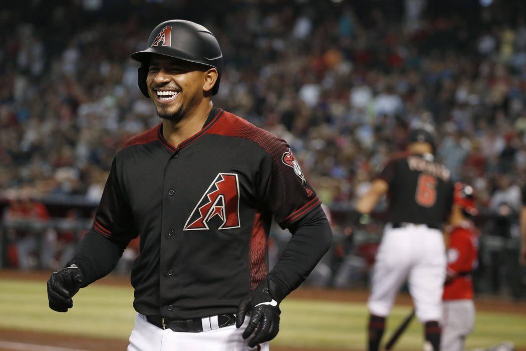 Arizona Diamondbacks' Eduardo Escobar smiles as he arrives back at the dugout after hitting a t ...