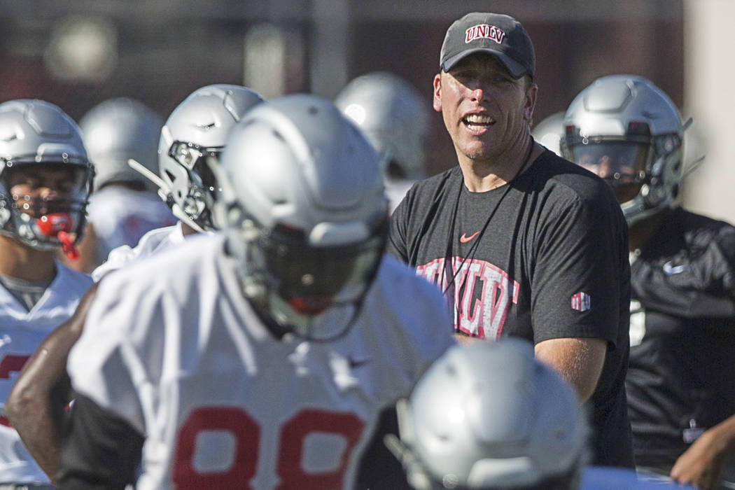 UNLV offensive coordinator Garin Justice, top/right, coaches up the Rebels during the first day ...