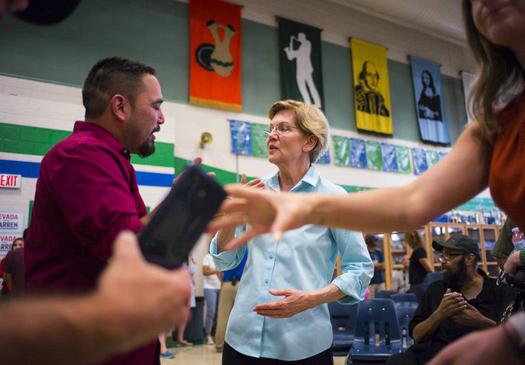 Democratic presidential candidate Sen. Elizabeth Warren, D-Mass., talks with supporters after s ...