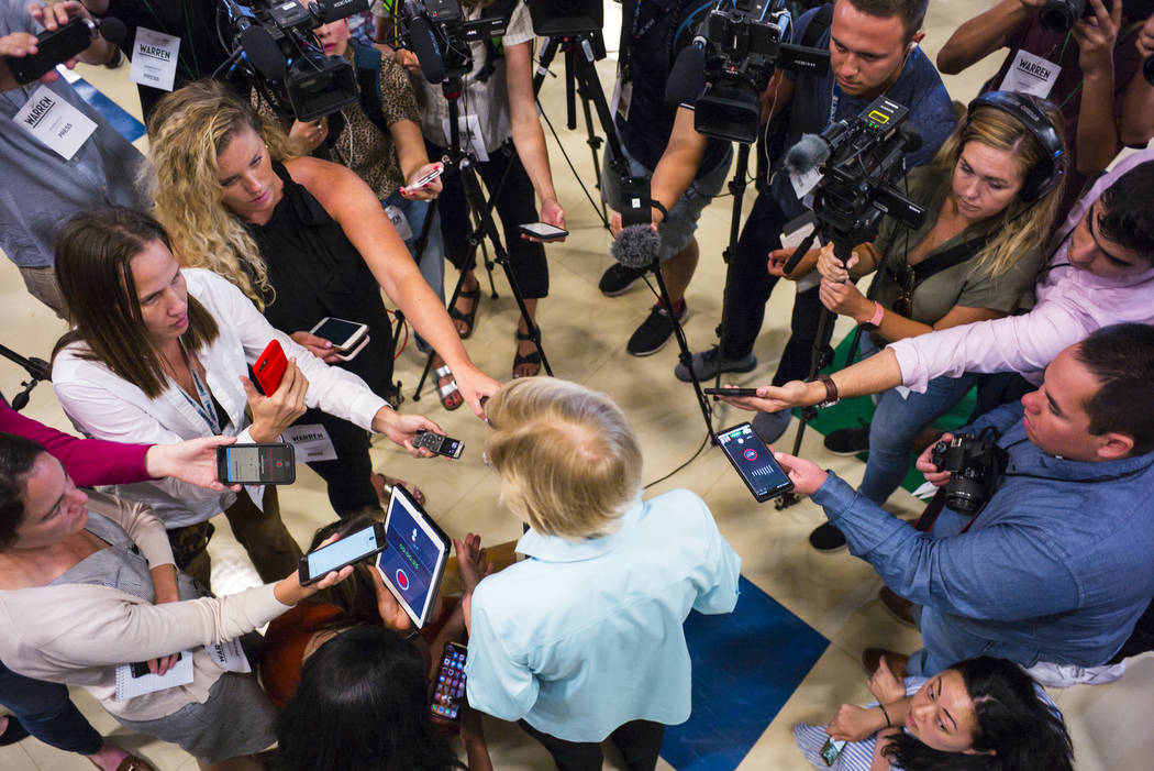 Democratic presidential candidate Sen. Elizabeth Warren, D-Mass., talks with members of the new ...