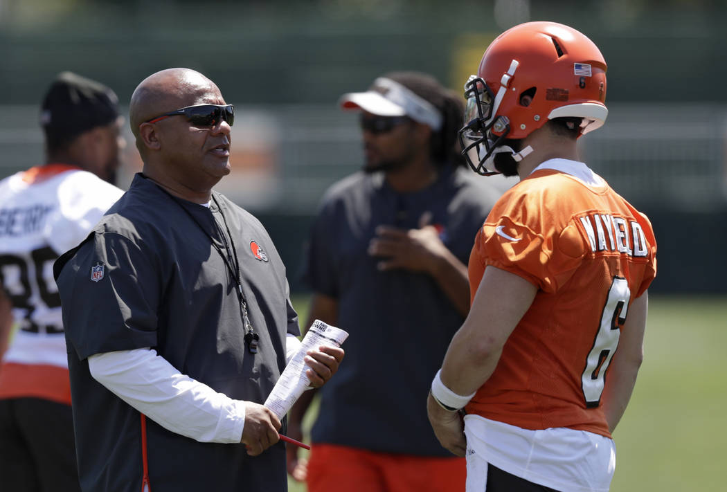 Cleveland Browns head coach Hue Jackson, left, talks with quarterback Baker Mayfield during NFL ...