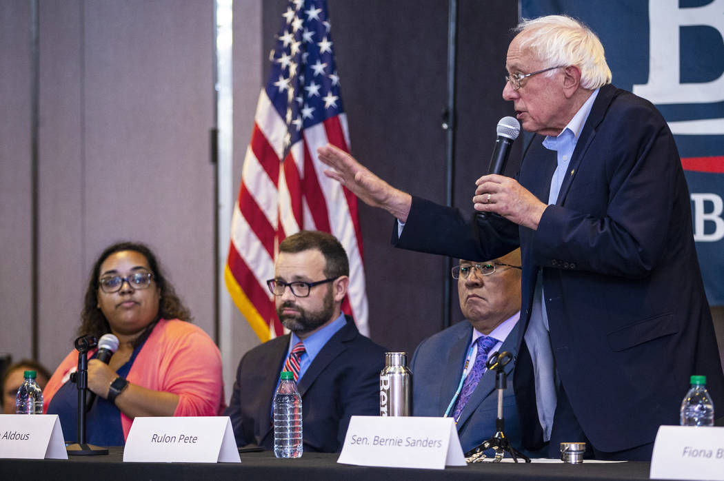 Democratic presidential candidate Sen. Bernie Sanders, I-Vt., right, speaks during and economic ...