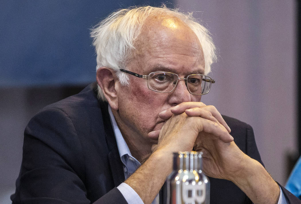 Democratic presidential candidate Sen. Bernie Sanders, I-Vt., listens to panel members speak du ...