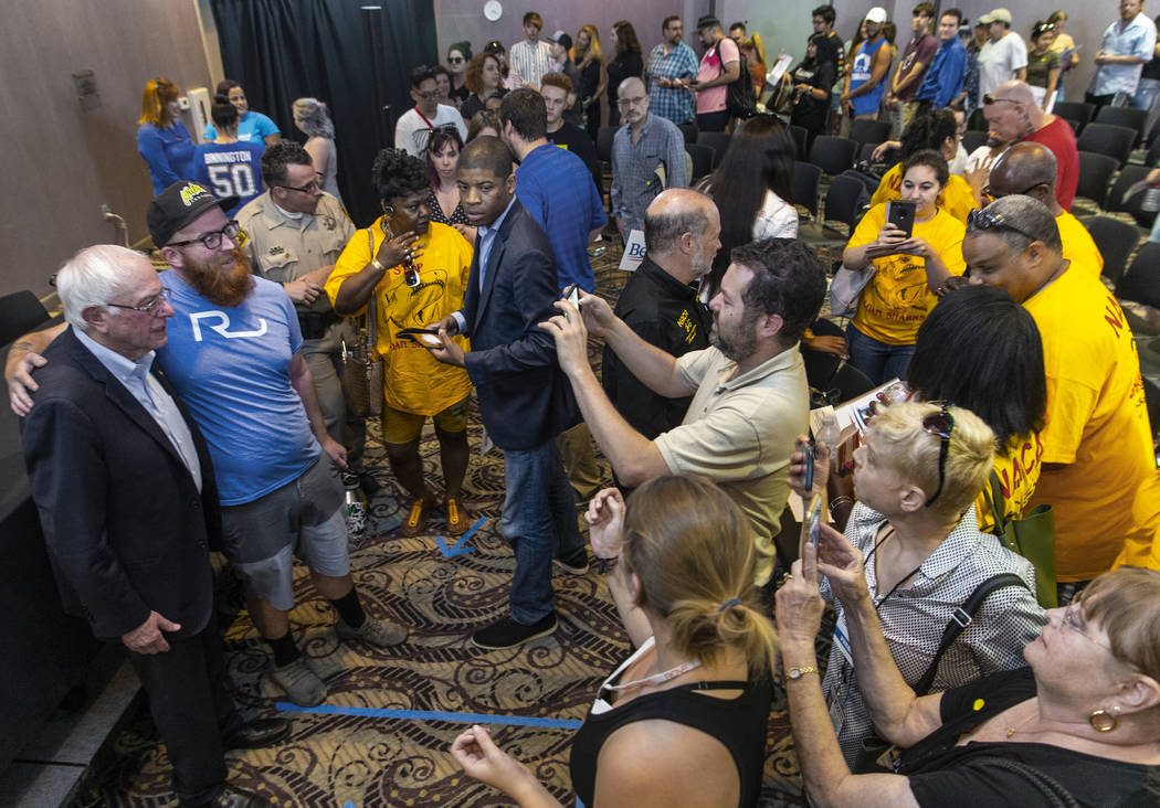 Democratic presidential candidate Sen. Bernie Sanders, I-Vt., bottom/left, takes photos with at ...