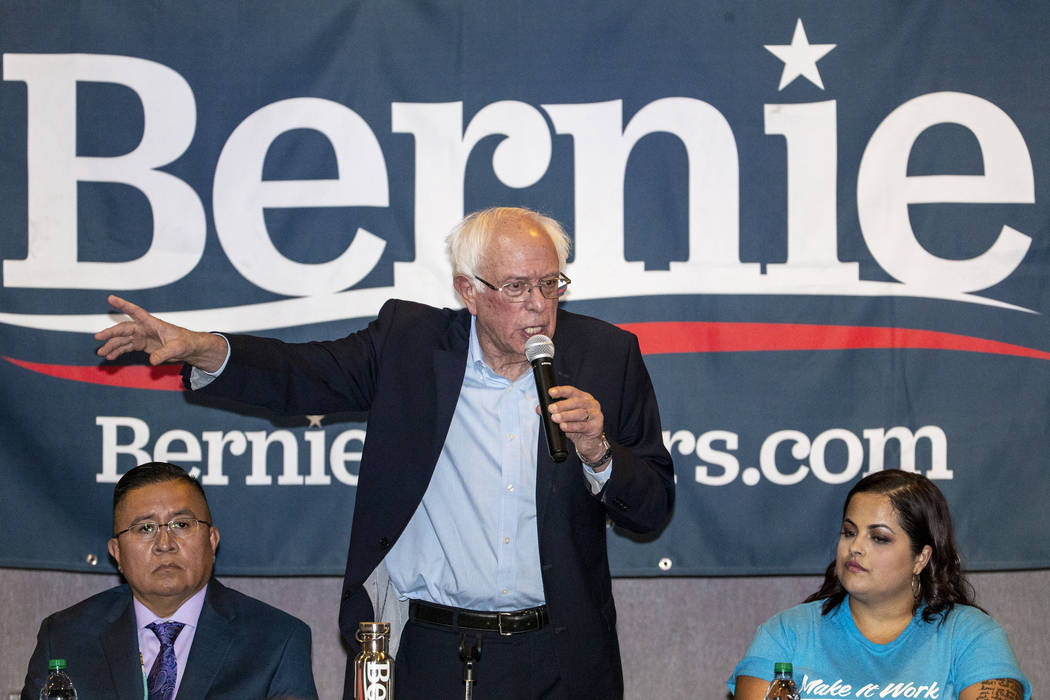 Democratic presidential candidate Sen. Bernie Sanders, I-Vt., center, speaks during and economi ...