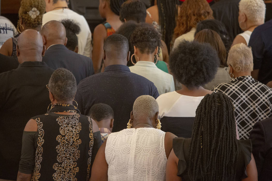 Church goers pray in a group during the second church service, with Democratic presidential can ...