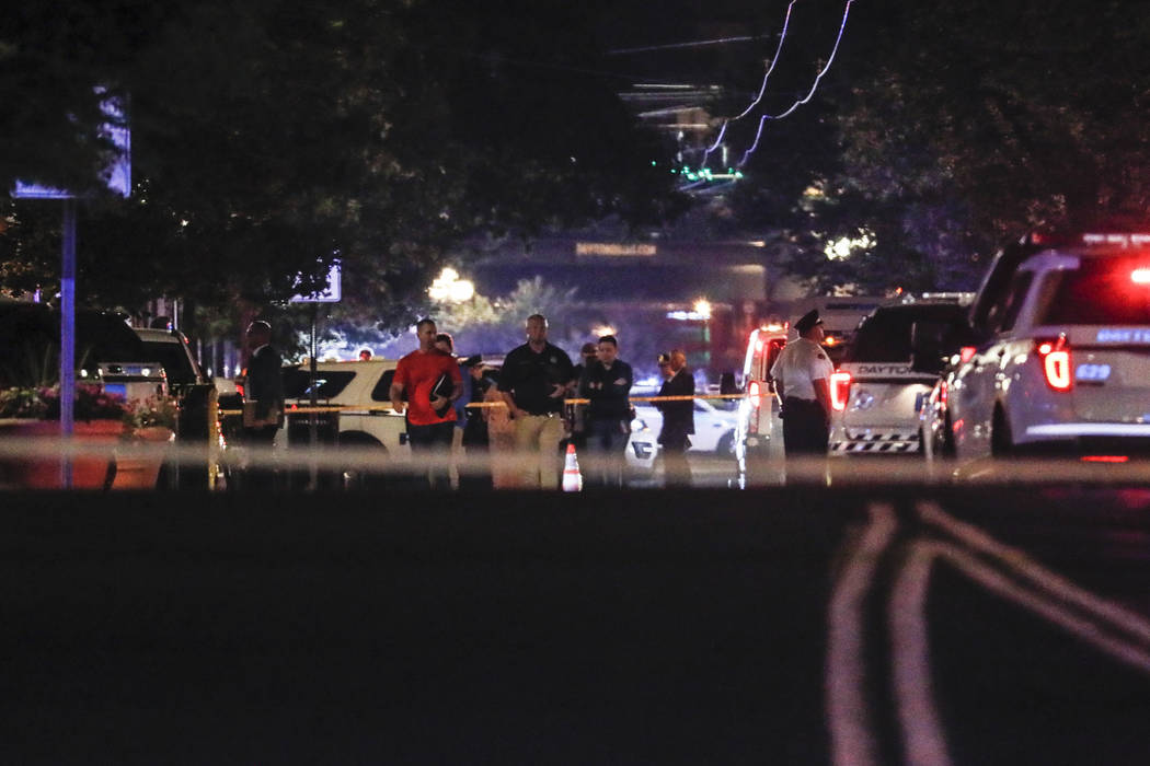 Authorities work at the scene of a mass shooting, Sunday, Aug. 4, 2019, in Dayton, Ohio. Severa ...