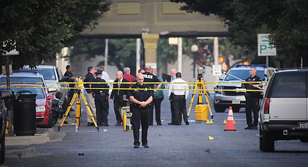 Dayton police look for evidence after a mass shooting in Dayton, Ohio on Sunday, Aug, 4, 2019. ...