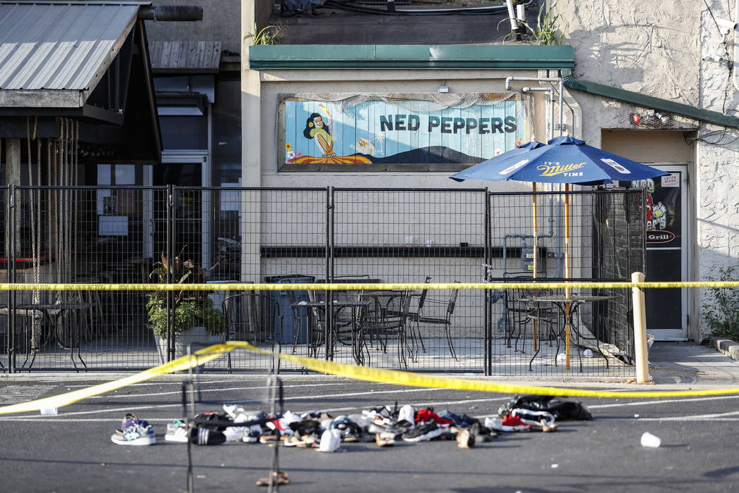 Shoes are piled outside the scene of a mass shooting including Ned Peppers bar, Sunday, Aug. 4, ...