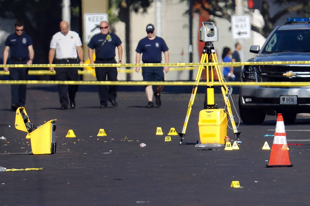 Evidence markers rest on the street at the scene of a mass shooting Sunday, Aug. 4, 2019, in Da ...