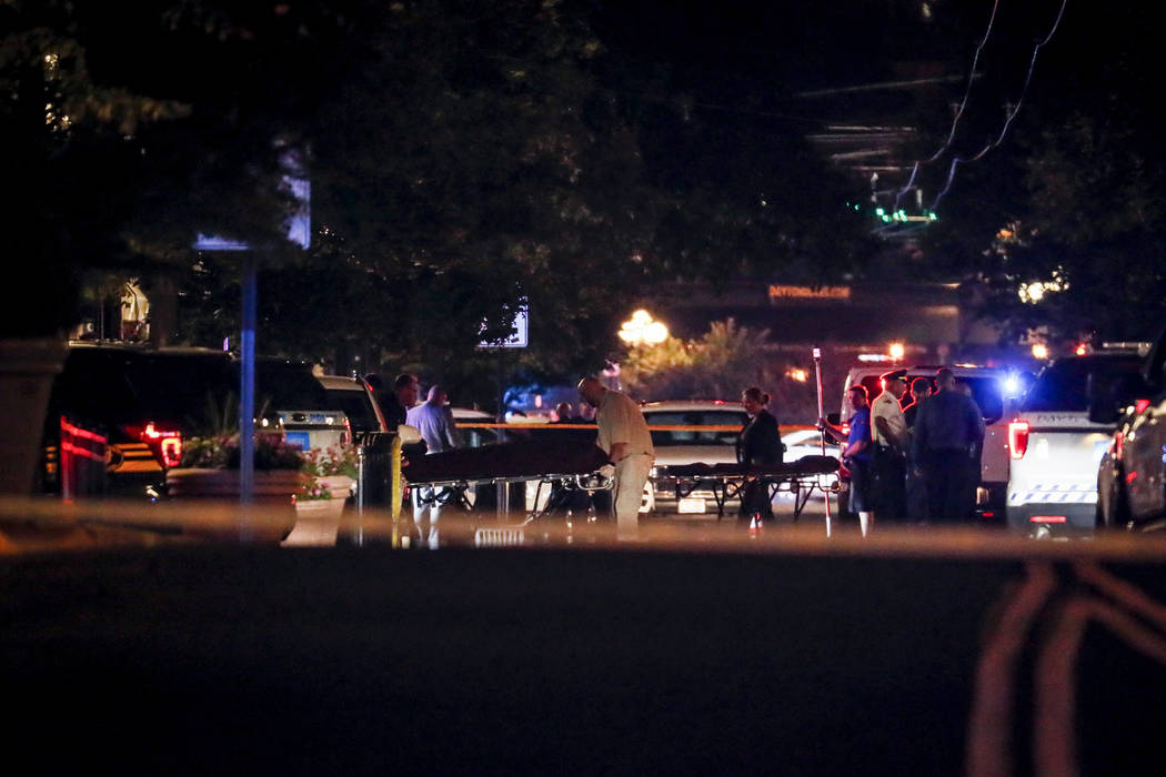 Bodies are removed from at the scene of a mass shooting, Sunday, Aug. 4, 2019, in Dayton, Ohio. ...