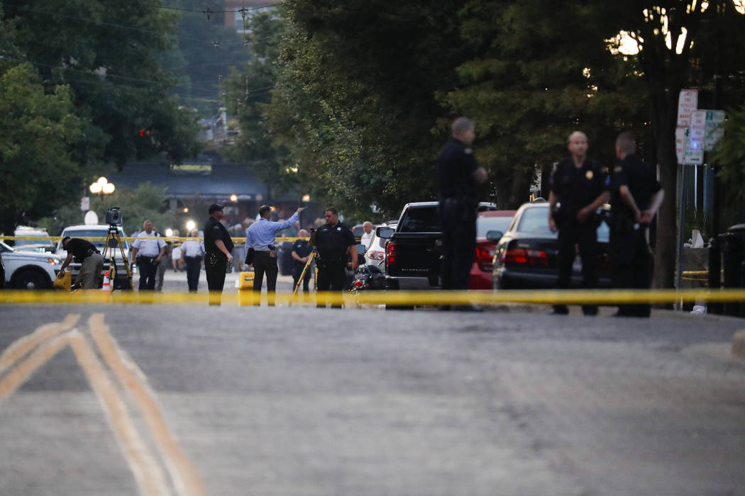 Authorities work the scene of a mass shooting, Sunday, Aug. 4, 2019, in Dayton, Ohio. Several p ...