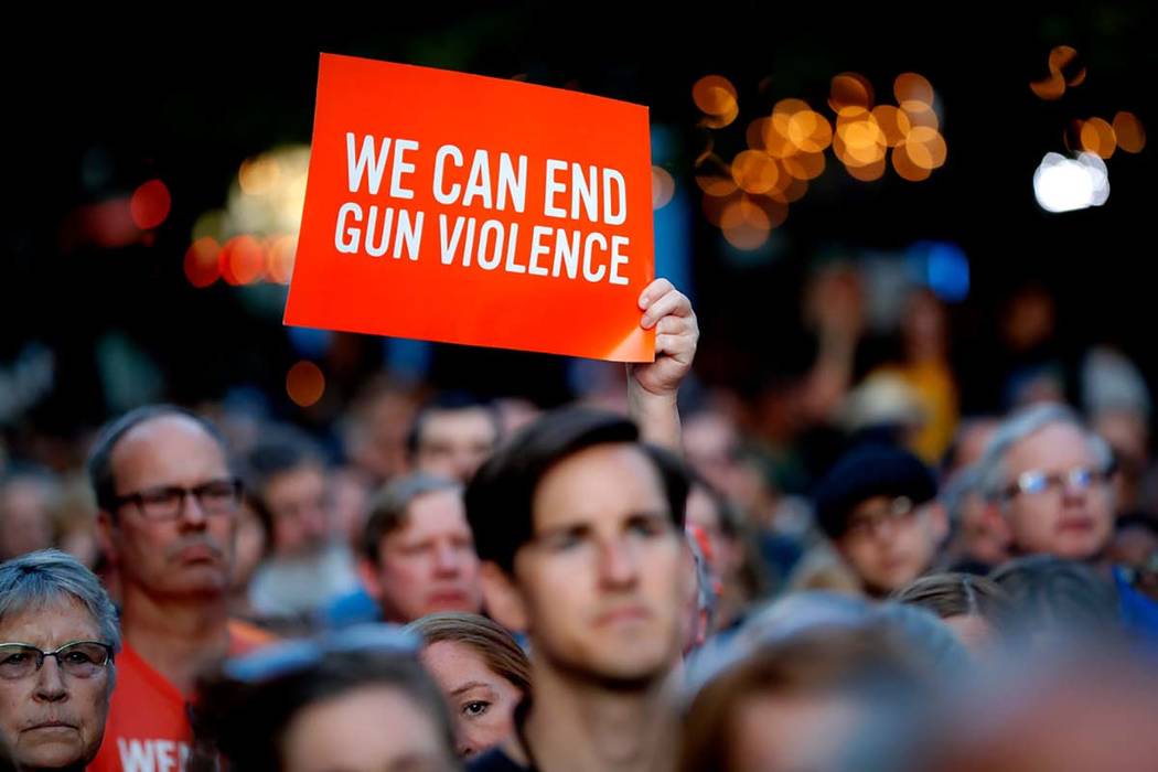 Mourners gather for a vigil at the scene of a mass shooting, Sunday, Aug. 4, 2019, in Dayton, O ...