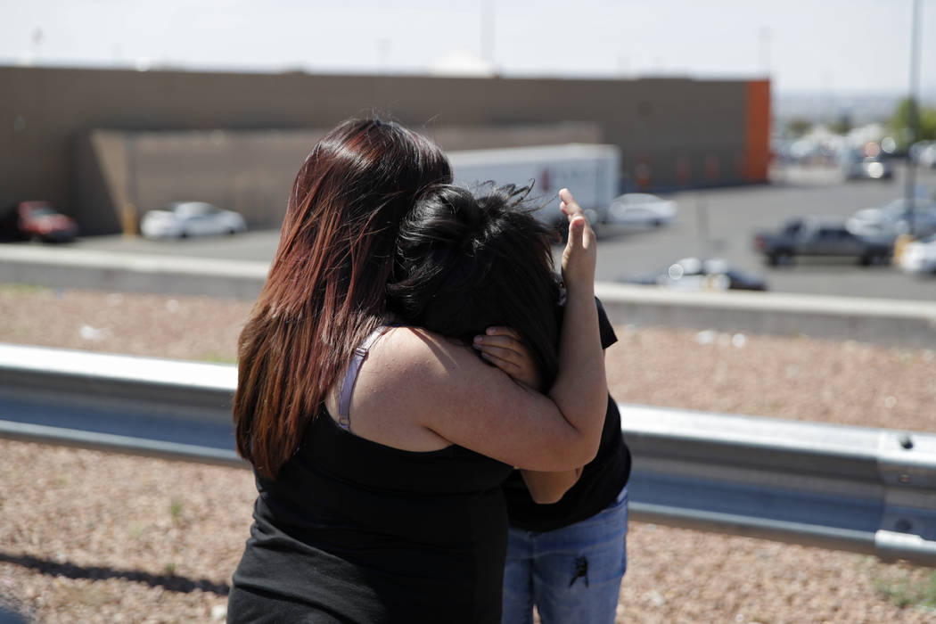 Eleven-year-old Leilani Hebben, right, embraces her mother Anabel Hebben as they visit the scen ...