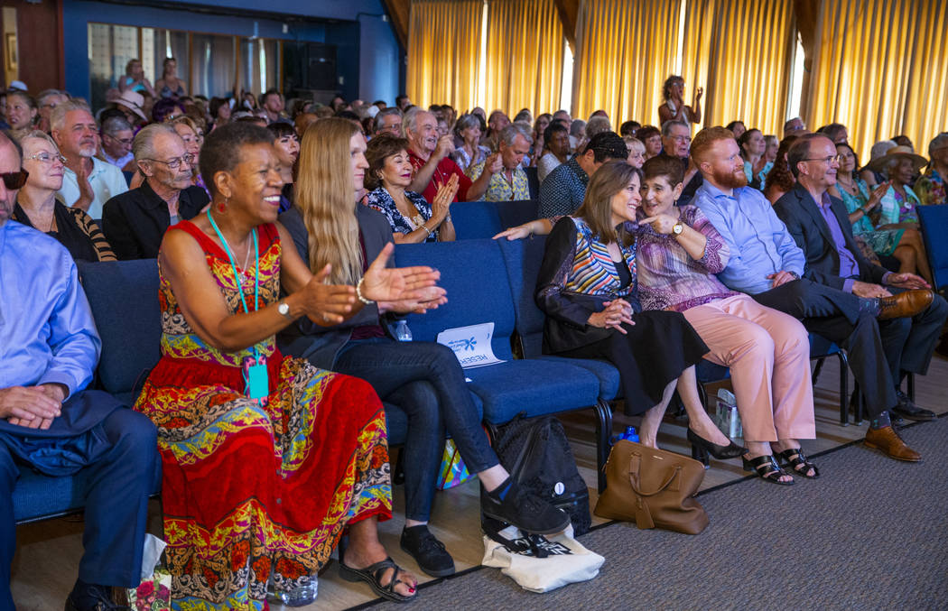 Democratic presidential candidate Marianne Williamson, center in front, joins the congregation ...