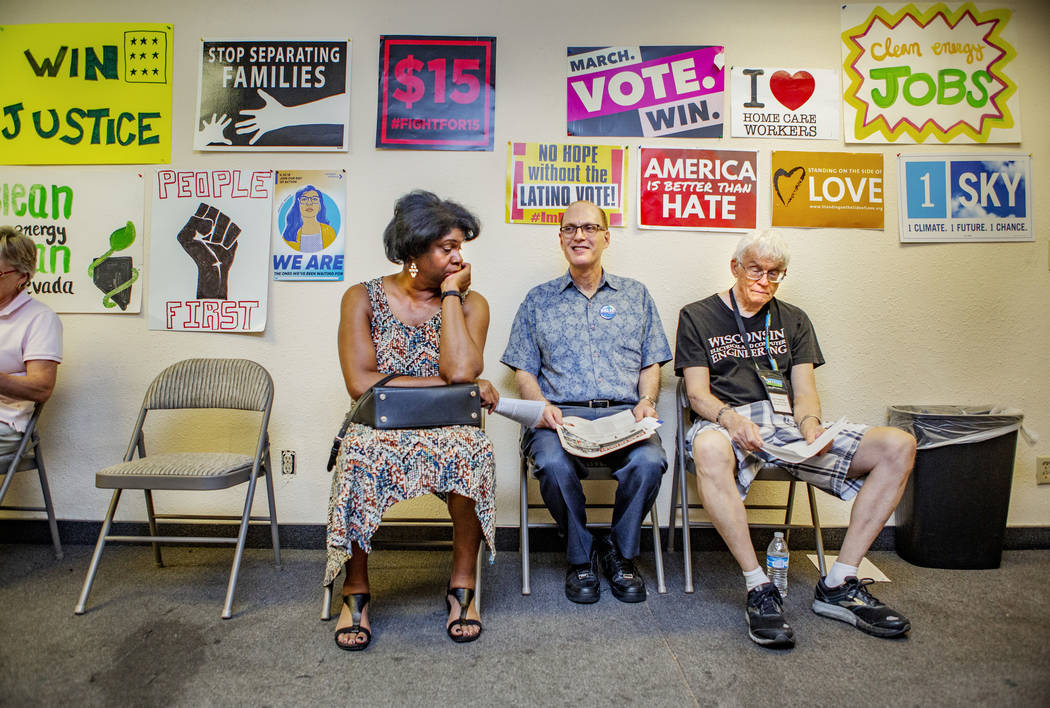 Lorraine Brown, Michael Nussbaum and Gary Vesperman, from Boulder City, sit as they wait for a ...