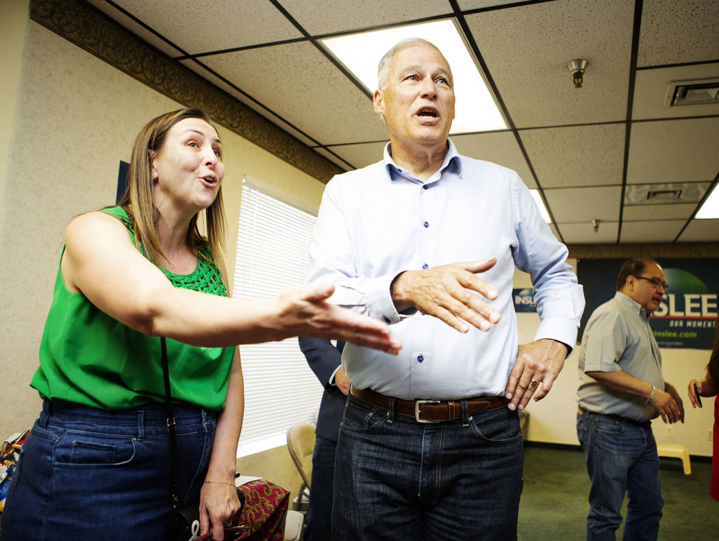 Democratic presidential candidate Washington Gov. Jay Inslee greets attendees with Assemblywom ...