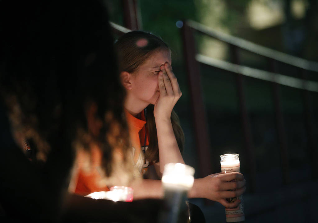 Sherie Gramlich reacts during a vigil for victims of a mass shooting that occurred earlier in t ...