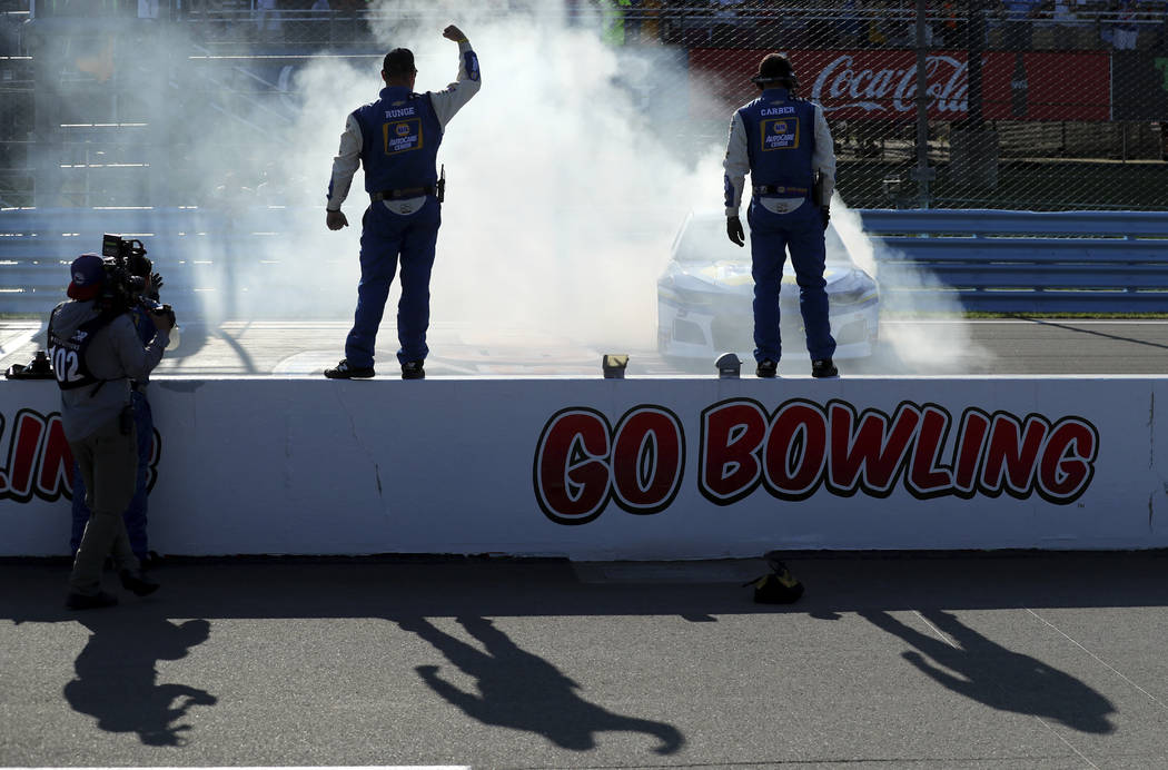 Chase Elliott does a celebratory burnout in front of his pit crew after winning a NASCAR Cup Se ...