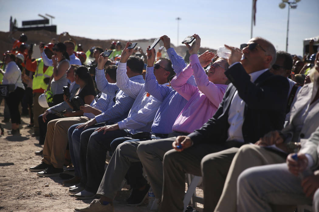 Attendees watch as steel beam is lifted during the Las Vegas Stadium Topping Out Ceremony in La ...