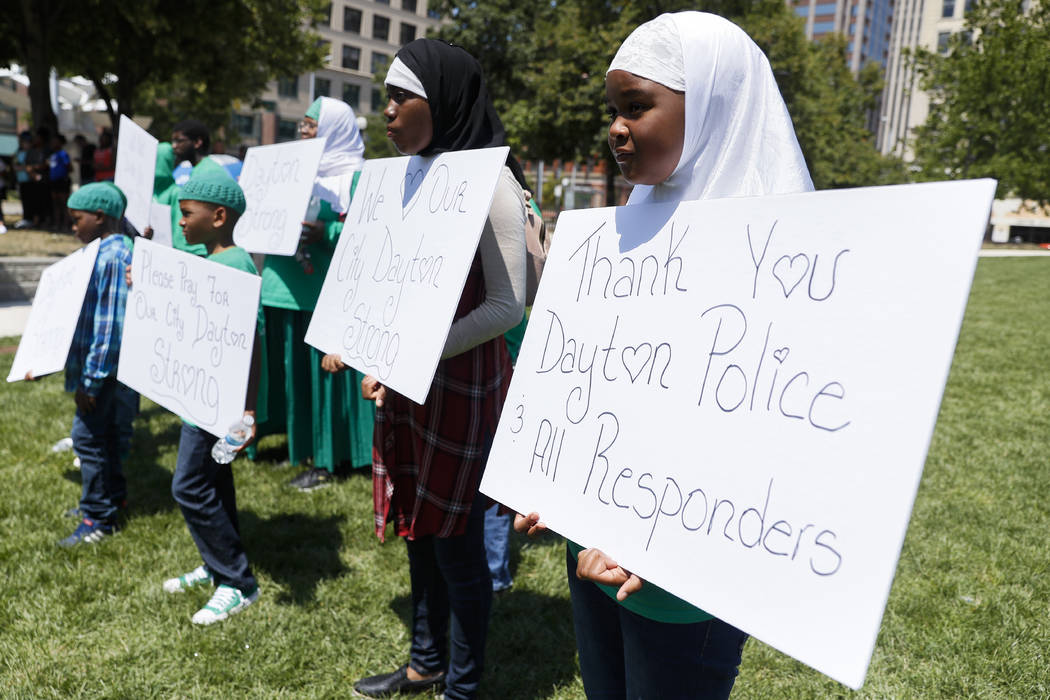 Mourners gather at a vigil following a nearby mass shooting, Sunday, Aug. 4, 2019, in Dayton, O ...