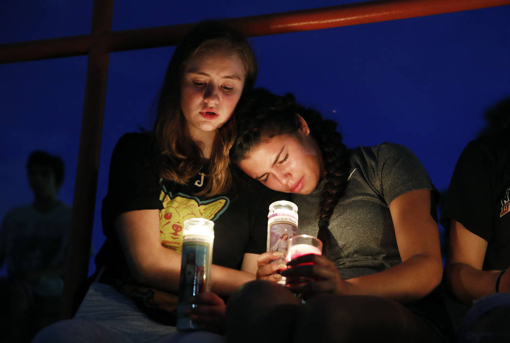 Melody Stout and Hannah Payan comfort each other during a vigil for victims of the shooting tha ...