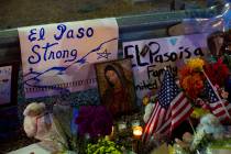 A Virgin Mary painting, flags and flowers adorn a makeshift memorial for the victims of Saturda ...