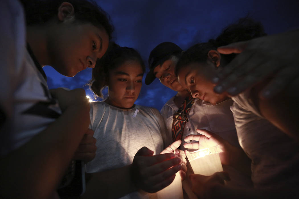 People gather in Juarez, Mexico, Saturday, Aug. 3, 2019, in a vigil for the 3 Mexican nationals ...