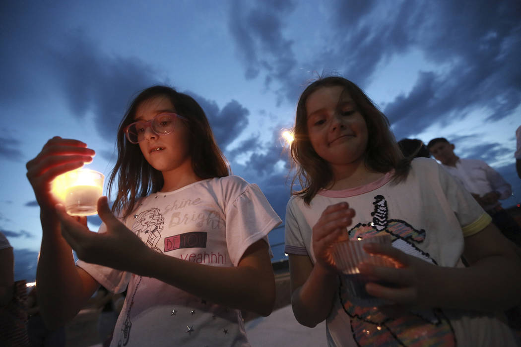 People gather in Juarez, Mexico, Saturday, Aug. 3, 2019, in a vigil for the 3 Mexican nationals ...