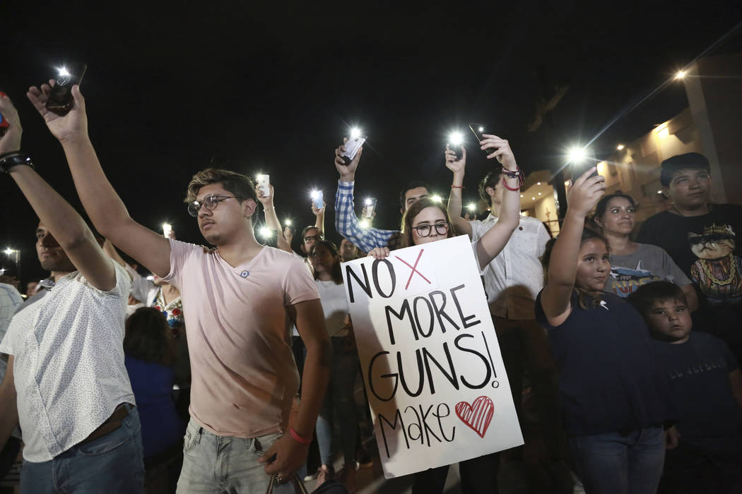 People gather in Juarez, Mexico, Saturday, Aug. 3, 2019, in a vigil for the 3 Mexican nationals ...