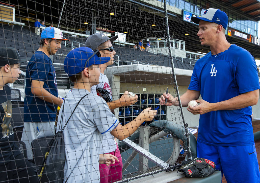 J.D. Martin, right, takes a moment out to sign a few autographs before his game with the Oklaho ...