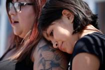 Eleven-year-old Leilani Hebben puts her head on her mother Anabel Hebben's shoulder as they vis ...