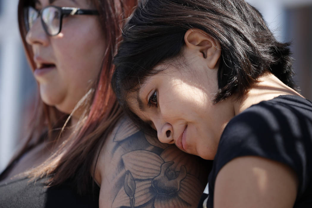 Eleven-year-old Leilani Hebben puts her head on her mother Anabel Hebben's shoulder as they vis ...