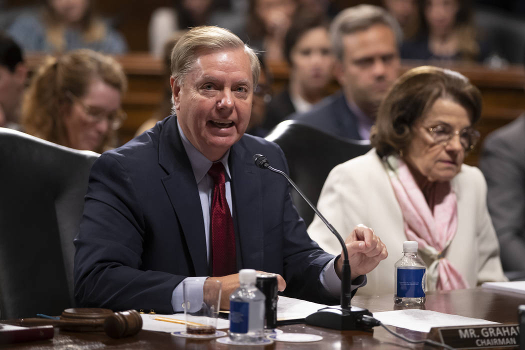 Senate Judiciary Committee Chairman Lindsey Graham, R-S.C., joined at right by Sen. Dianne Fein ...