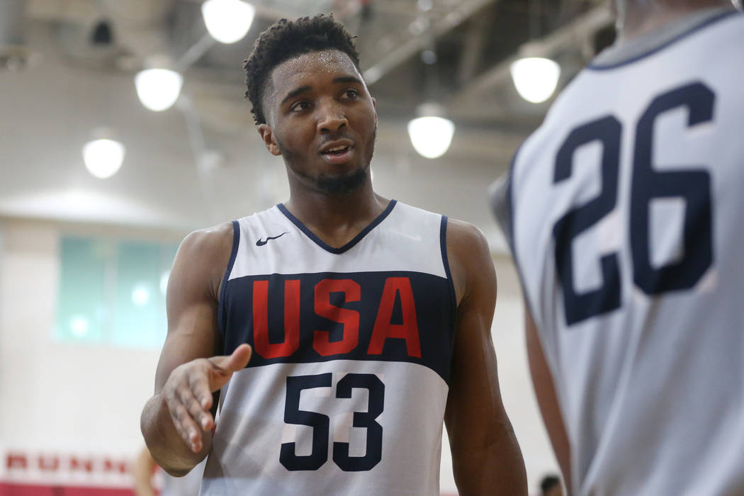 Utah Jazz guard Donovan Mitchell (53) speaks to Boston Celtics guard Kemba Walker (26) during t ...