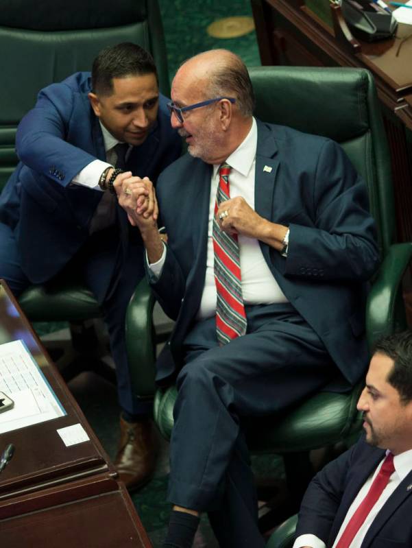 Luis "Junior" Perez, center, shakes hands with fellow lawmakers Urayoan Hernandez as ...