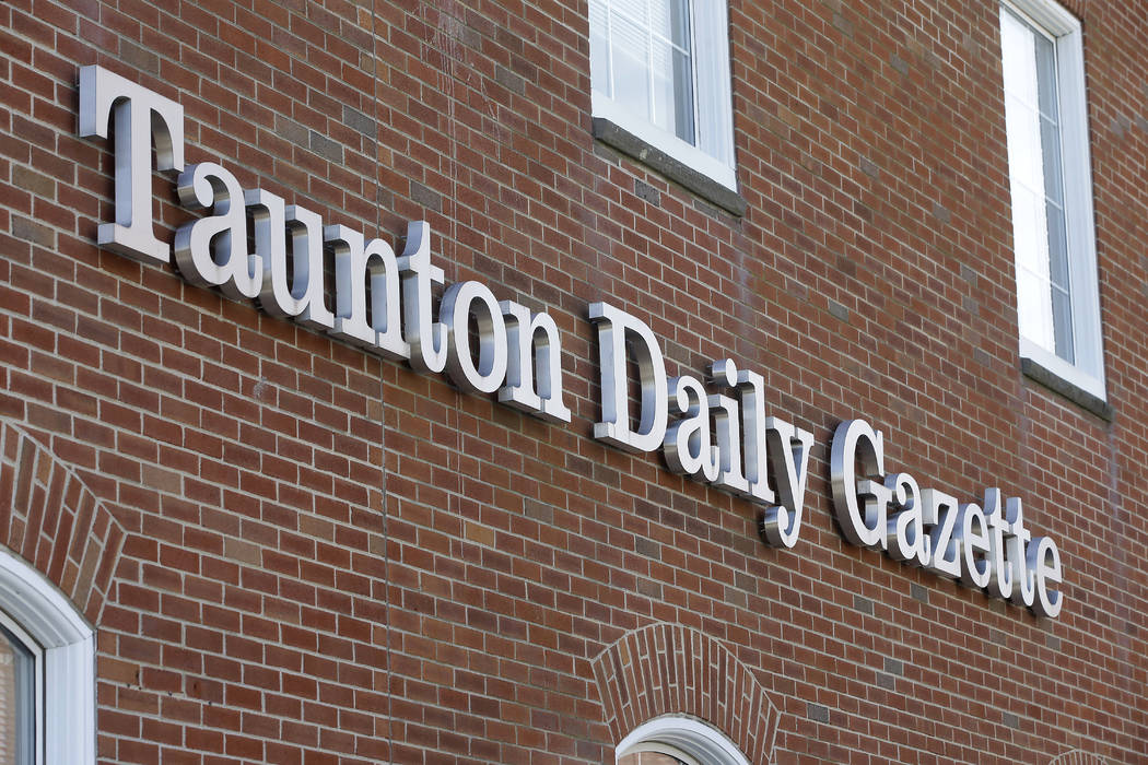 In this Monday, Aug. 5, 2019 photo a Taunton Daily Gazette sign is attached to the exterior of ...