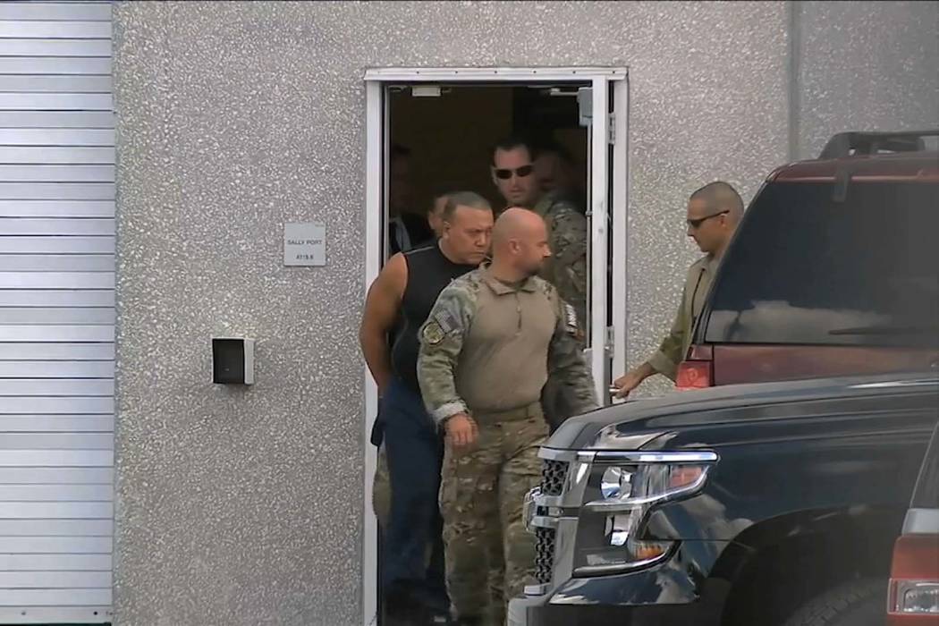 This frame grab from video shows FBI agents escorting Cesar Sayoc, in sleeveless shirt, in Mira ...