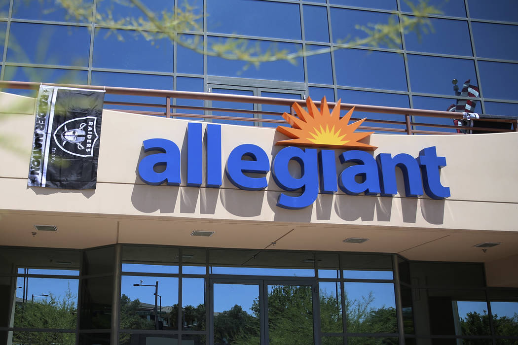 A Raiders flag hangs in front of the Allegiant headquarters in Las Vegas, Monday, Aug. 5, 2019. ...