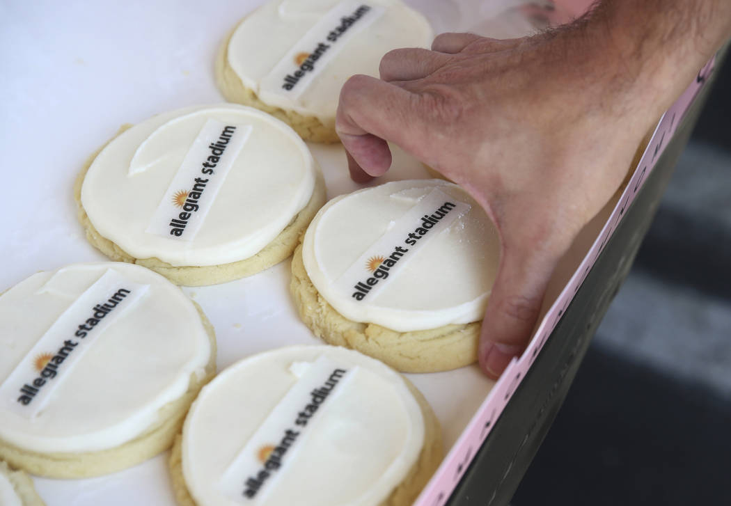 Allegiant Stadium branded cookies are given out to employees during an event to celebrate the n ...