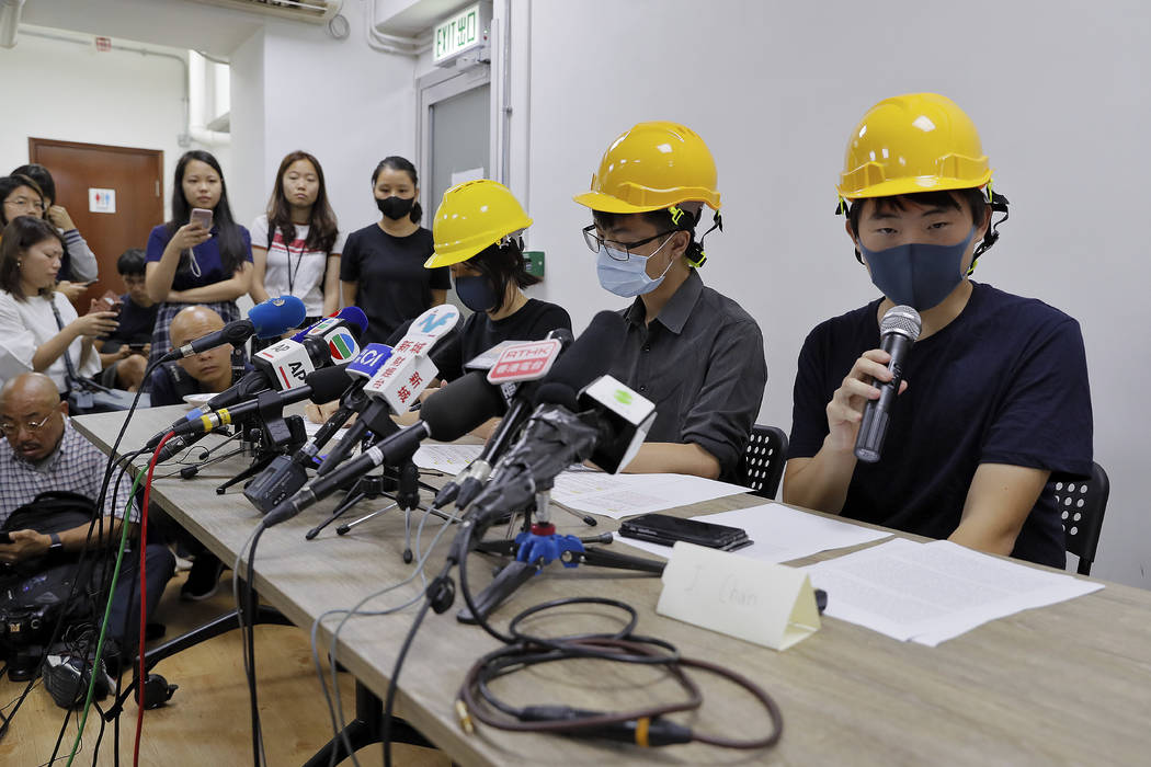 Protesters from right, Jerry Chan, Linus Kim and Mary Tsang attend a press conference in Hong K ...