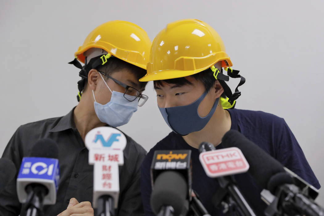 Protesters Jerry Chan, right, chats with Linus Kim during a press conference in Hong Kong, Tues ...