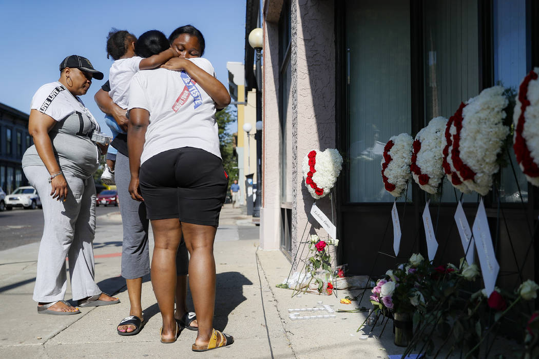 Family members of slain mass shooting victim Thomas "TJ" McNichols, from left, Donna ...