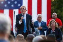 Ohio Gov. Mike DeWine, left, speaks alongside Dayton Mayor Nan Whaley, right, during a vigil at ...