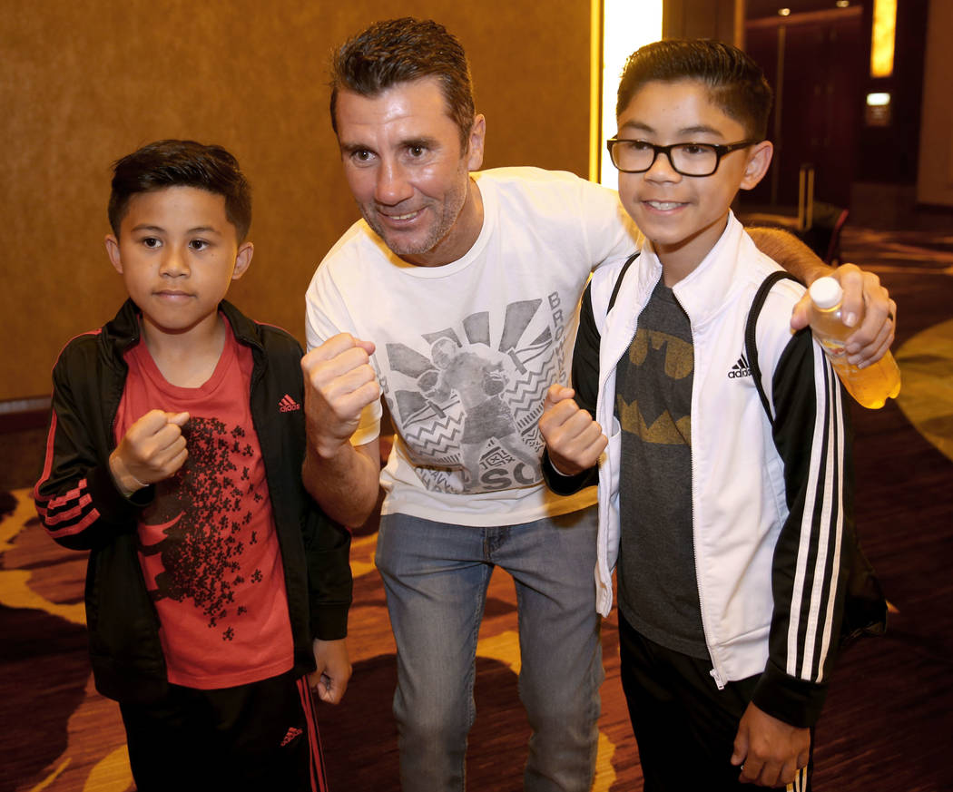 Nevada Boxing Hall of Fame inductee Wayne McCullough visits with fans Ethan Cal, 12, and Reagan ...